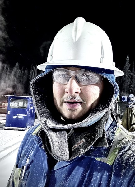 Ricardo Esteban in the field at -40, hard hat and safety glasses frosted over
